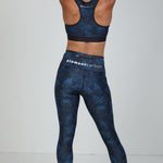 Rear view of woman in Midnight Blue Hexagon leggings and sports bra